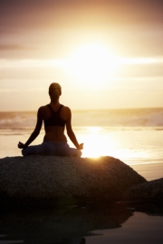 Woman Meditating at Sunset